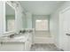 This bathroom features a double sink vanity with marble countertops, a soaking tub, and tile flooring at 4735 Longcourt Se Dr, Atlanta, GA 30339
