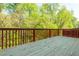 Wooden deck with railing offering views of the surrounding green trees at 4735 Longcourt Se Dr, Atlanta, GA 30339