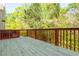 Wooden deck with railing offering views of the surrounding green trees at 4735 Longcourt Se Dr, Atlanta, GA 30339