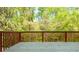 Wooden deck with railing offering views of the surrounding green trees at 4735 Longcourt Se Dr, Atlanta, GA 30339