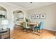 Dining room with stylish table and view of kitchen and arched openings at 4735 Longcourt Se Dr, Atlanta, GA 30339