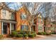 Beautiful brick townhome showcasing detailed architecture, complemented by lush greenery and a cozy entrance at 4735 Longcourt Se Dr, Atlanta, GA 30339