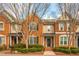 Charming brick townhome featuring manicured landscaping, a welcoming entrance, and classic architectural details at 4735 Longcourt Se Dr, Atlanta, GA 30339