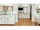 Open kitchen with breakfast bar overlooking the living room fireplace at 4735 Longcourt Se Dr, Atlanta, GA 30339