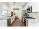 Modern kitchen showcases stainless steel appliances, white cabinets, and a breakfast bar at 4735 Longcourt Se Dr, Atlanta, GA 30339