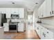 Open kitchen with stainless appliances, sleek white cabinetry, and stylish countertops at 4735 Longcourt Se Dr, Atlanta, GA 30339