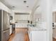 Modern kitchen featuring white cabinetry, stainless steel appliances, granite countertops, and hardwood floors at 4735 Longcourt Se Dr, Atlanta, GA 30339