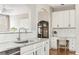 Bright eat-in kitchen with a built in desk space, white cabinetry, and modern appliances at 4735 Longcourt Se Dr, Atlanta, GA 30339