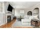 Bright open-concept living room with fireplace, hardwood floors, and neutral color palette at 4735 Longcourt Se Dr, Atlanta, GA 30339