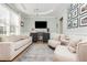 Bright living room features a tray ceiling, hardwood floors, plush seating, and a modern entertainment area at 4735 Longcourt Se Dr, Atlanta, GA 30339
