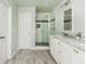 This bathroom features a spacious shower, vanity with marble countertops, and wood-style flooring at 4735 Longcourt Se Dr, Atlanta, GA 30339