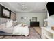 Spacious main bedroom featuring a large bed, tray ceilings, and lots of natural light at 4735 Longcourt Se Dr, Atlanta, GA 30339