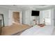 Bright main bedroom suite features neutral carpeting, TV, and private entry to the main bathroom at 4735 Longcourt Se Dr, Atlanta, GA 30339