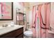 Unique bathroom with a vanity, patterned shower curtain, and pink accents at 1023 Bentley Estates Dr, Dacula, GA 30019
