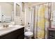 Bright bathroom featuring floral shower curtain, and a vanity with sink at 1023 Bentley Estates Dr, Dacula, GA 30019