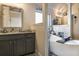 Elegant bathroom featuring a soaking tub and granite countertop vanity at 1023 Bentley Estates Dr, Dacula, GA 30019