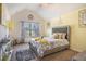 Sunlit bedroom with vaulted ceiling, stylish decor, and a comfortable bed at 1023 Bentley Estates Dr, Dacula, GA 30019