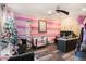 Fun bedroom featuring pink wall stripes, modern ceiling fan, and wood flooring at 1023 Bentley Estates Dr, Dacula, GA 30019