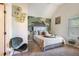 Stylish bedroom with unique wall art, comfortable bed, and cozy chair at 1023 Bentley Estates Dr, Dacula, GA 30019