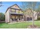 Charming two-story brick home with a well-manicured lawn and inviting front porch at 1023 Bentley Estates Dr, Dacula, GA 30019
