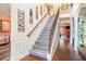Grand foyer with hardwood floors, staircase, and decorative wrought iron railing at 1023 Bentley Estates Dr, Dacula, GA 30019