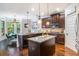 Bright kitchen featuring dark wood cabinets, granite countertops, and stainless steel appliances at 1023 Bentley Estates Dr, Dacula, GA 30019