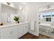 Bright bathroom featuring a double sink vanity and a view into bedroom at 1123 W Marietta St, Atlanta, GA 30318