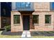 Up-close view of brick home with landscaped entryway and a modern black front door at 1123 W Marietta St, Atlanta, GA 30318