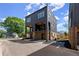 Modern townhome showing brick foundation and dark siding with balcony and attached garage at 1123 W Marietta St, Atlanta, GA 30318
