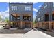 Modern townhome showing brick foundation and dark siding with balcony and attached garage at 1123 W Marietta St, Atlanta, GA 30318