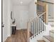 Bright foyer featuring hardwood floors, a staircase with black railings, and modern decor at 1123 W Marietta St, Atlanta, GA 30318