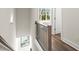 Bright hallway featuring hardwood floors, modern railing and a window view at 1123 W Marietta St, Atlanta, GA 30318
