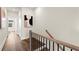 Hallway with stairs featuring a wooden railing, art, and plenty of natural light at 1123 W Marietta St, Atlanta, GA 30318
