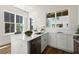 Bright kitchen features an island, stainless steel dishwasher, and white cabinets at 1123 W Marietta St, Atlanta, GA 30318