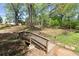 Scenic view of a wooden bridge spanning a creek, surrounded by lush trees and greenery at 1123 W Marietta St, Atlanta, GA 30318