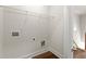 Empty laundry room area with hardwood floors, wall outlets and wire shelving at 1123 W Marietta St, Atlanta, GA 30318