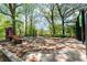 Park-like outdoor seating area in the shade with tables, benches and landscaping at 1123 W Marietta St, Atlanta, GA 30318