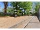 Community playground with green playground equipment surrounded by wood mulch at 1123 W Marietta St, Atlanta, GA 30318