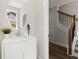 Compact powder room featuring a modern vanity, mirror, and hardwood floors, plus stairs in view at 1123 W Marietta St, Atlanta, GA 30318