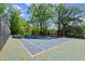 Fenced tennis court surrounded by large trees at 1123 W Marietta St, Atlanta, GA 30318