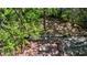 Aerial view of backyard with a deck, dining set, lush trees, and a playset at 1711 Homestead Ne Ave, Atlanta, GA 30306