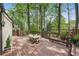 Expansive back deck with a dining set, bench, and lush greenery surroundings at 1711 Homestead Ne Ave, Atlanta, GA 30306