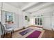 Bright exercise room featuring hardwood floors, exposed beams, and natural light at 1711 Homestead Ne Ave, Atlanta, GA 30306