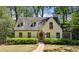 Charming home featuring a stone walkway, dormer windows, and lush landscaping at 1711 Homestead Ne Ave, Atlanta, GA 30306