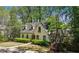 Charming home nestled among mature trees, featuring dormer windows and stone accents at 1711 Homestead Ne Ave, Atlanta, GA 30306
