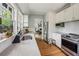 Updated kitchen with stainless steel appliances, tile backsplash, stone countertops, and hardwood flooring at 1711 Homestead Ne Ave, Atlanta, GA 30306