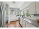 Charming kitchen featuring white cabinets, stainless steel appliances, hardwood floors and natural light at 1711 Homestead Ne Ave, Atlanta, GA 30306