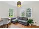 Cozy living room featuring a sleeper sofa, desk, hardwood floors and natural light at 1711 Homestead Ne Ave, Atlanta, GA 30306