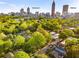 Aerial view overlooking a neighborhood with a skyline view of downtown Atlanta and Midtown at 327 6Th Ne St, Atlanta, GA 30308