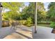 Backyard with a wood patio deck with an outdoor dining table, mature trees, and a fenced-in yard at 327 6Th Ne St, Atlanta, GA 30308